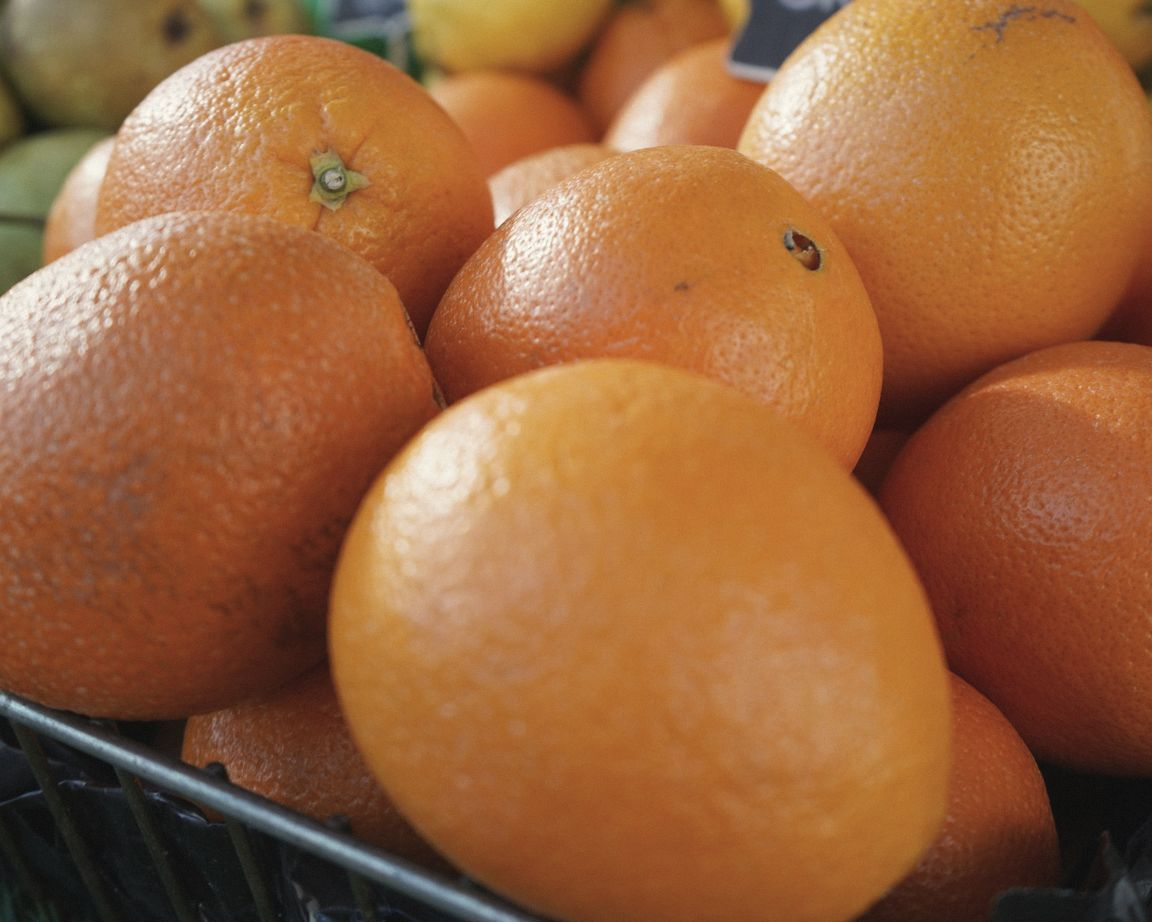 Oranges piled in a market crate