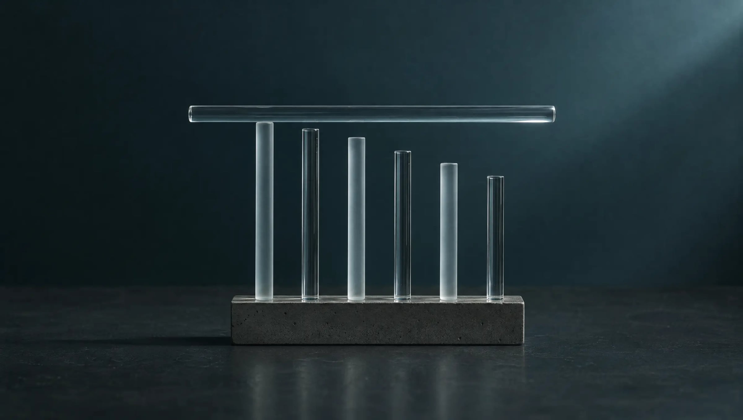 Six glass rods of different lengths with one level glass bar resting across them