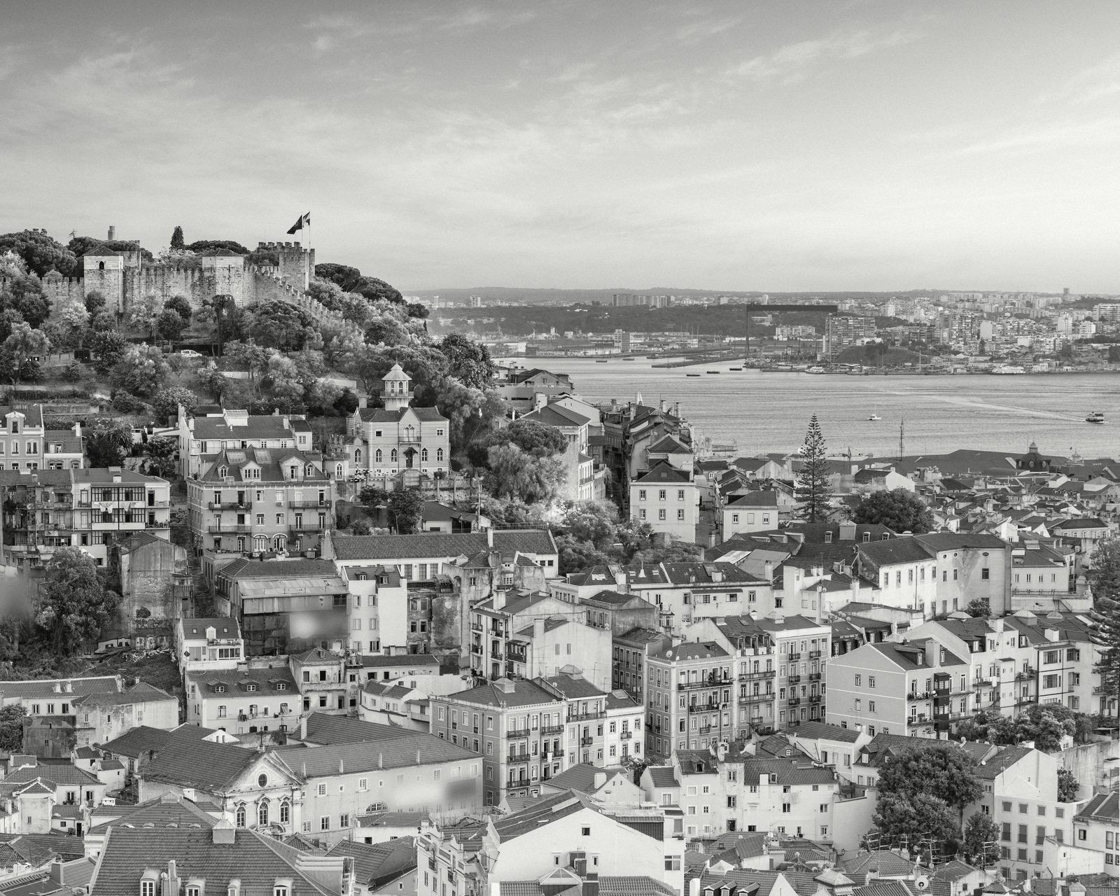 Lisbon rooftops above the river at sunset