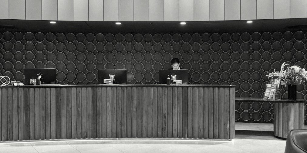 A hotel reception desk with a member of staff at work