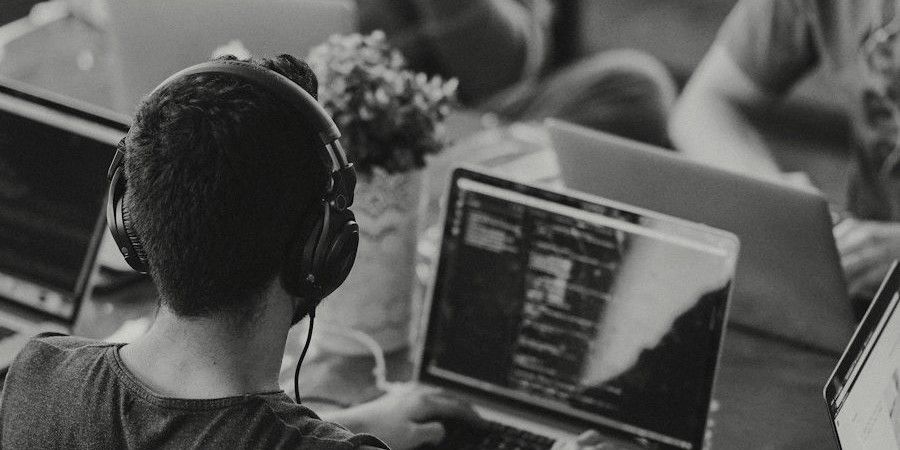 Engineers working on laptops around a shared table
