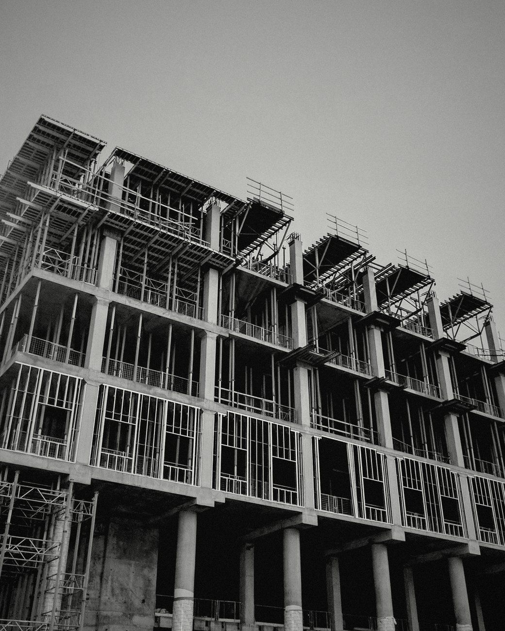 A concrete building under construction, floors still open