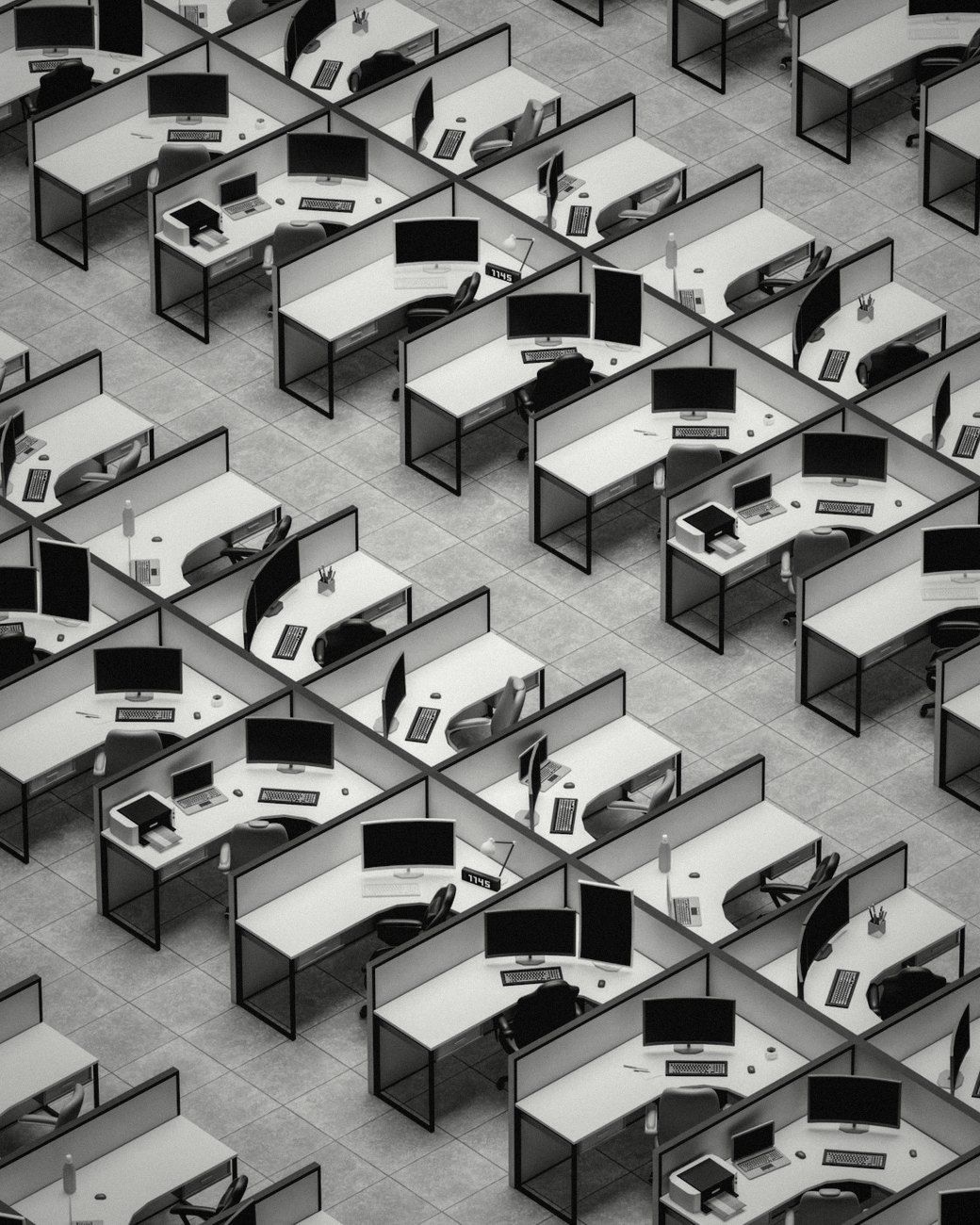 Rows of empty office desks seen from above