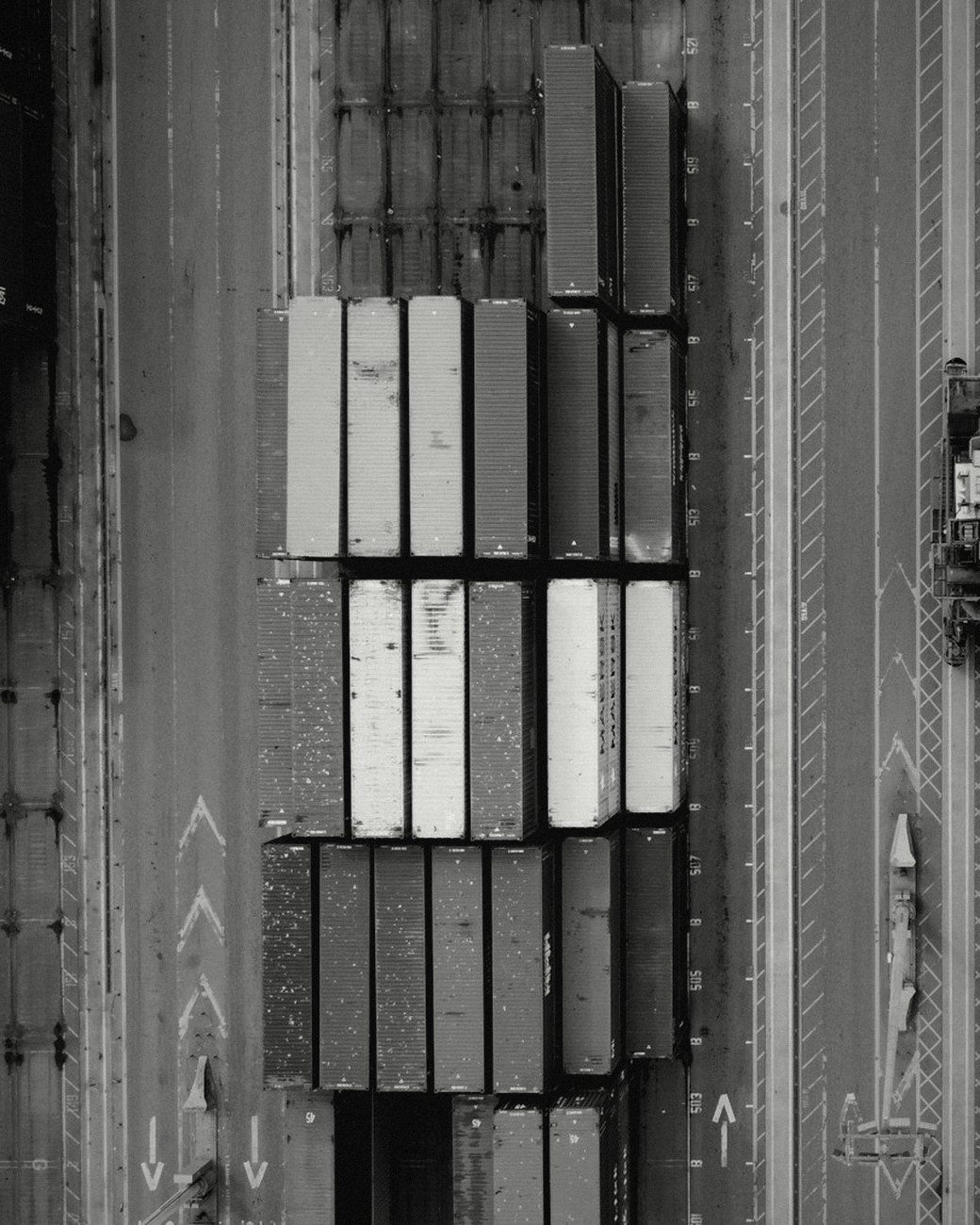 Shipping containers stacked at a port, seen from above